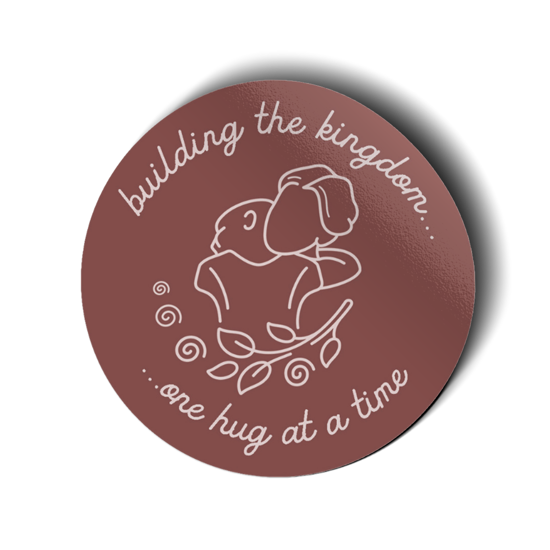 Vinyl sticker with a design featuring two people hugging and the text 'building the kingdom...one hug at a time'