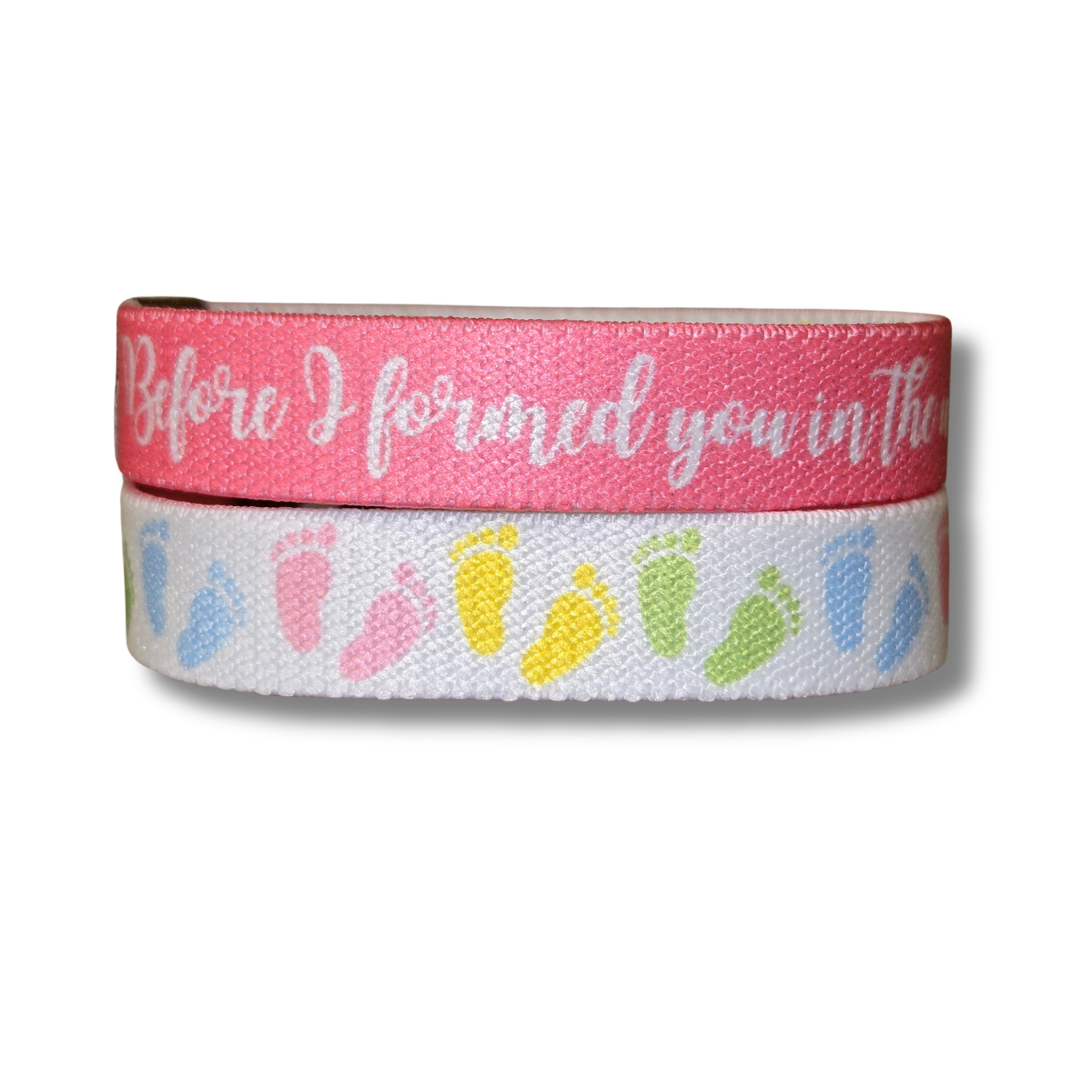 Pro-life Womens TruthBand from Pink Salt Riot- elastic wristband with pastel baby feet on one side and white words on pink background on the other side