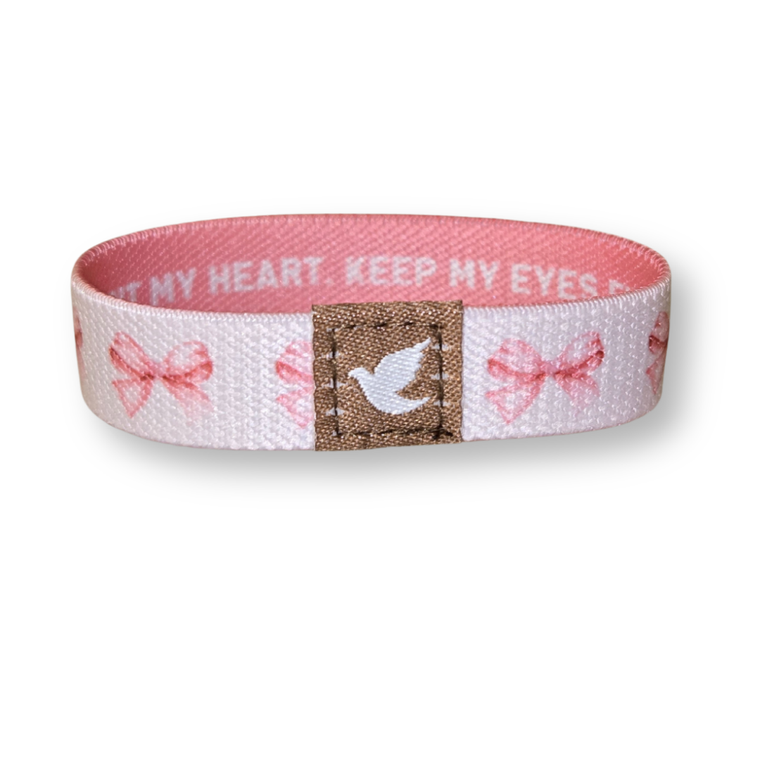 Pink Salt Riot Christian girls bracelet with pink bows and a white dove emblem